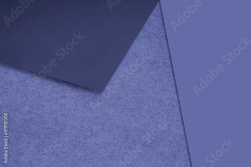 Plain and Textured pastel blue purple papers randomly laying to form M like pattern and triangle for creative cover design idea