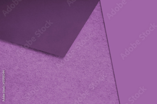 Plain and Textured purple papers randomly laying to form M like pattern and triangle for creative cover design idea