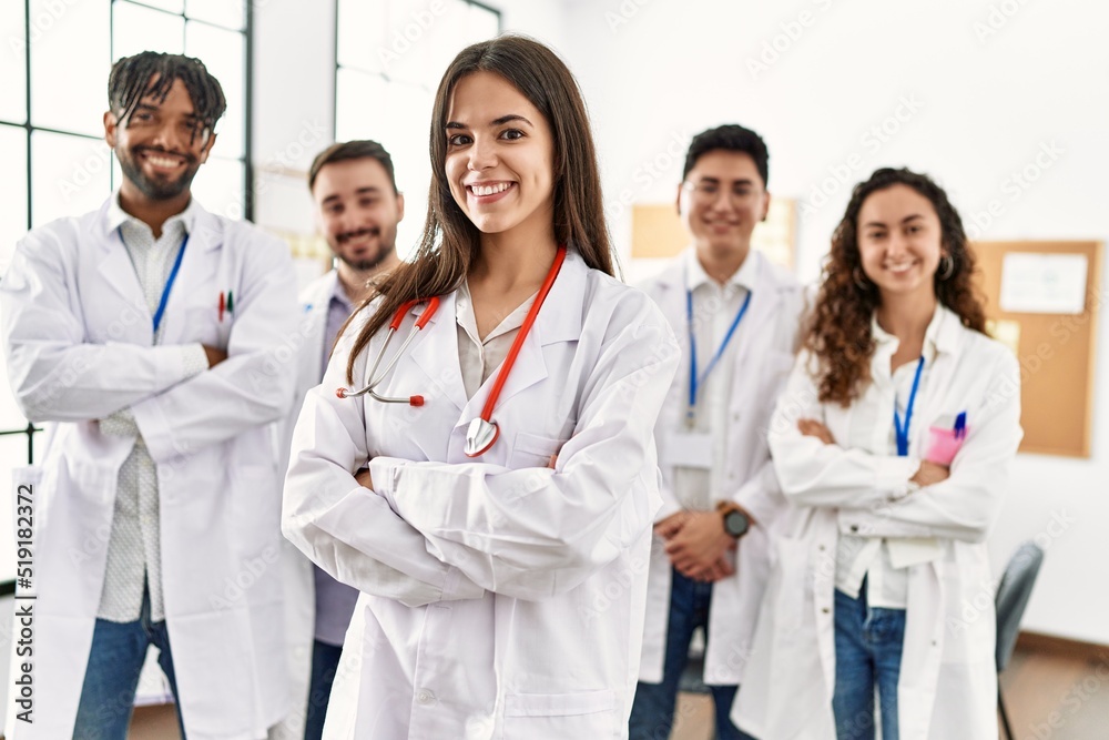 Group of young doctor smiling happy standing with arms crossed gesture at the clinic office. Group of young doctor smiling happy standing with arms crossed gesture at the clinic office.