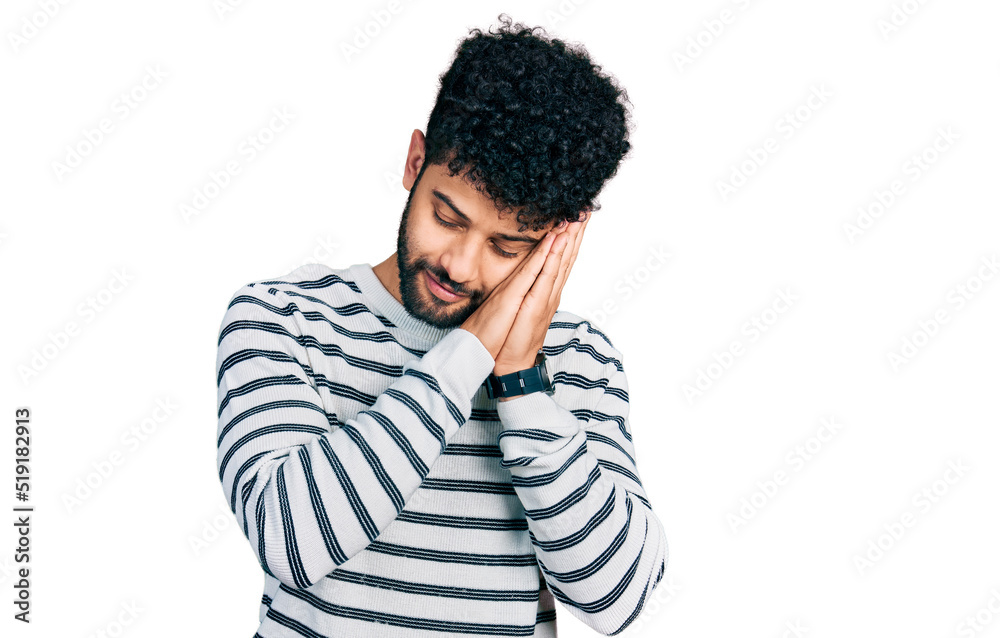 Young arab man with beard wearing casual striped sweater sleeping tired dreaming and posing with hands together while smiling with closed eyes. Young arab man with beard wearing casual striped sweater sleeping tired dreaming and posing with hands together while smiling with closed eyes.
