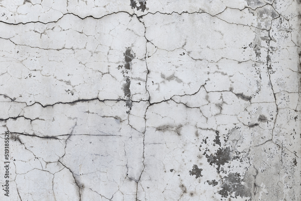 Obraz premium Closeup of badly fixed building facade wall covered with cracks in stucco and paint.