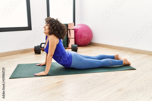 Young middle east woman smiling confident stretching at sport center