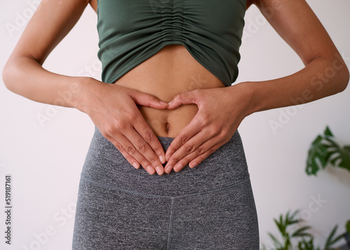 Close up of a multi-ethnic woman's hands on her stomach photo
