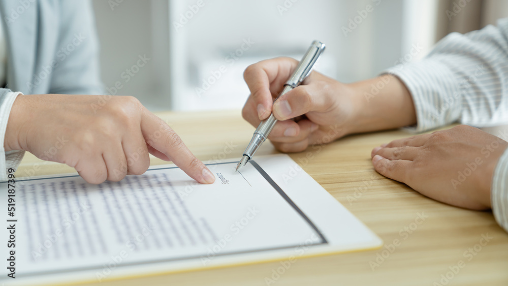 Home loan insurance. .Real estate broker and client sign contract insurance agreement document. Business meeting concept Home loan insurance. .Real estate broker and client sign contract insurance agreement document. Business meeting concept