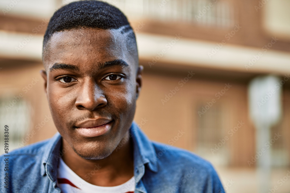 Young african american man smiling happy standing at the city. Young african american man smiling happy standing at the city.
