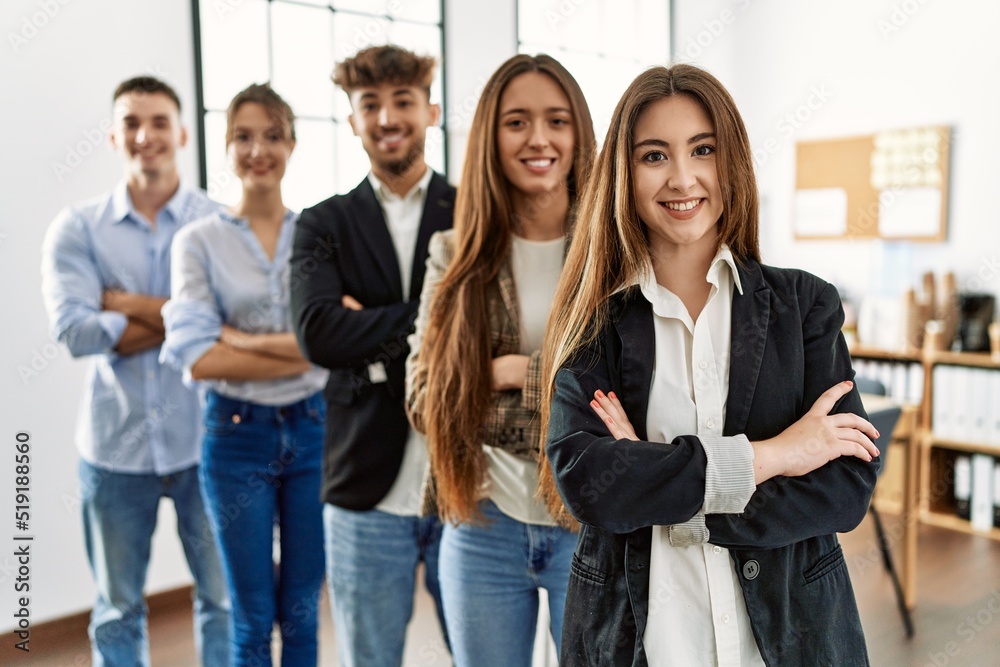 Obraz premium Group of young business workers smiling happy standing with arms crossed gesture at the office.