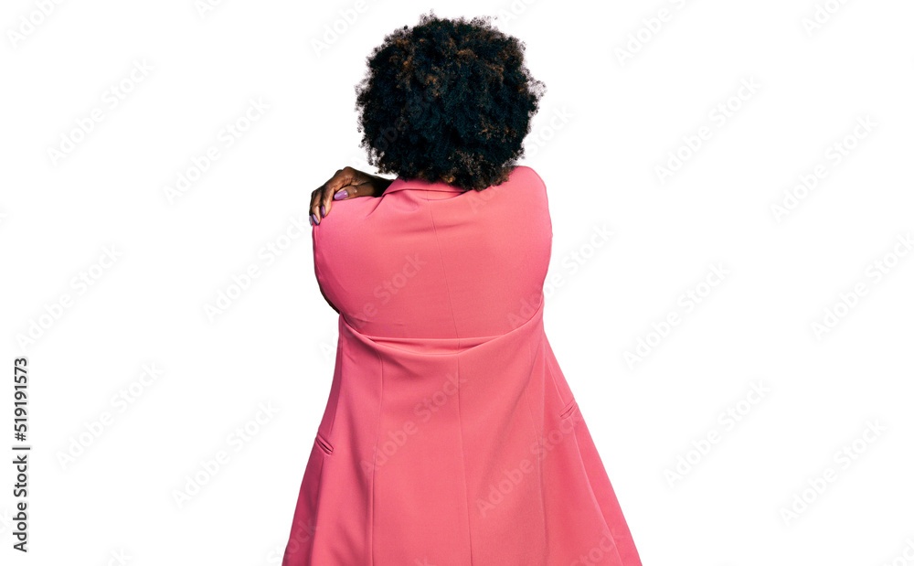 African american woman with afro hair wearing business jacket hugging oneself happy and positive from backwards. self love and self care African american woman with afro hair wearing business jacket hugging oneself happy and positive from backwards. self love and self care