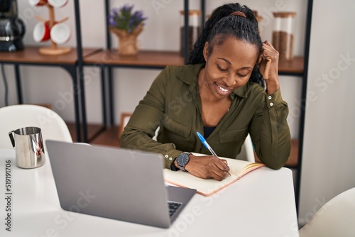 African american woman smiling confident studying at home