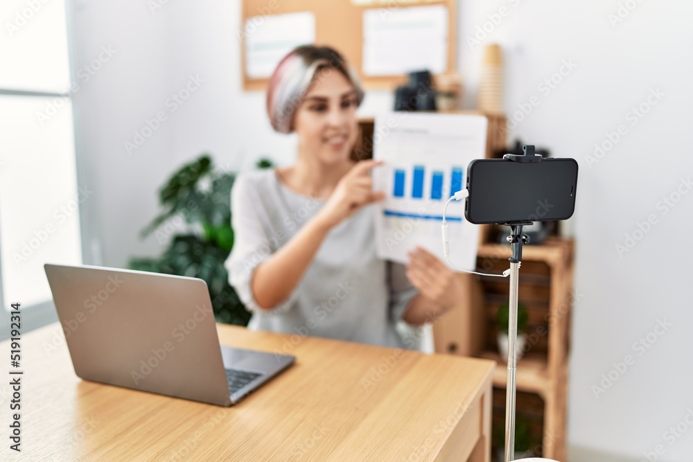 Young caucasian businesswoman smiling happy having video call at the office. Young caucasian businesswoman smiling happy having video call at the office.