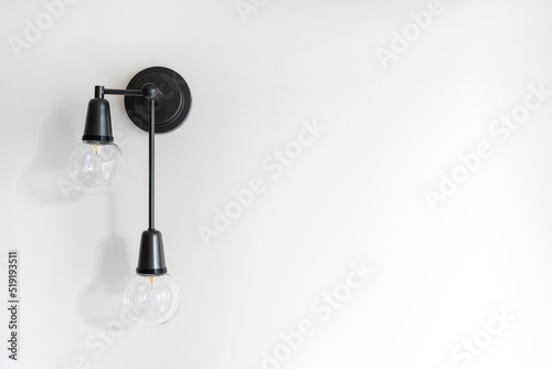 Fototapeta Naklejka Na Ścianę i Meble -  Energy saving lamp in black metal sconce