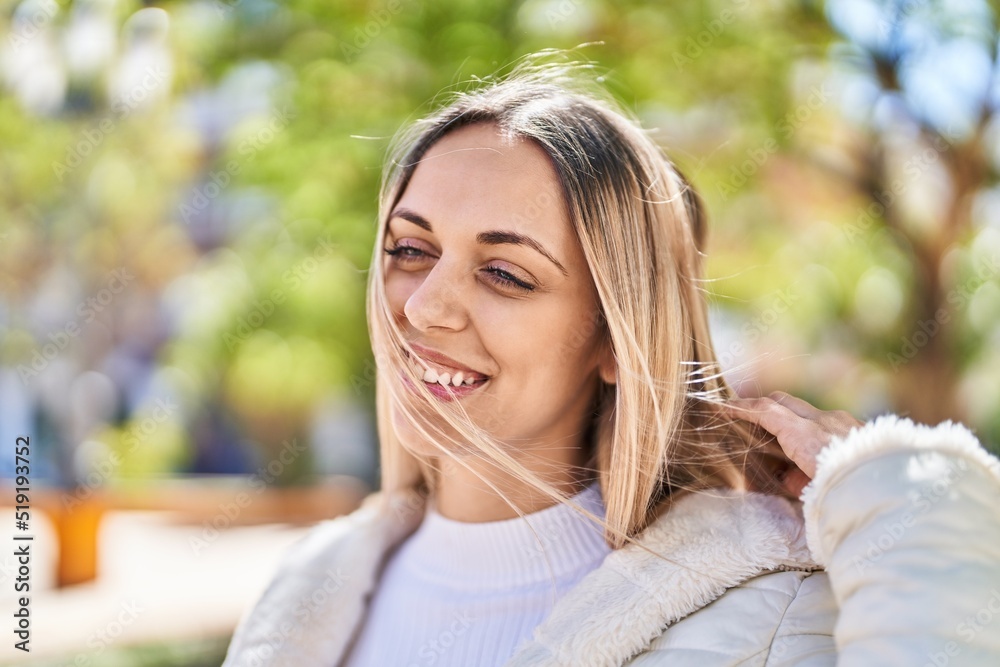 Young woman smiling confident standing at park