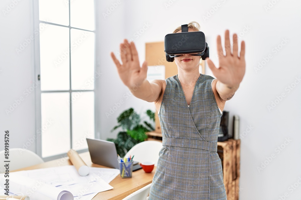 Young caucasian woman smiling confident using vr goggles working at architecture studio Young caucasian woman smiling confident using vr goggles working at architecture studio