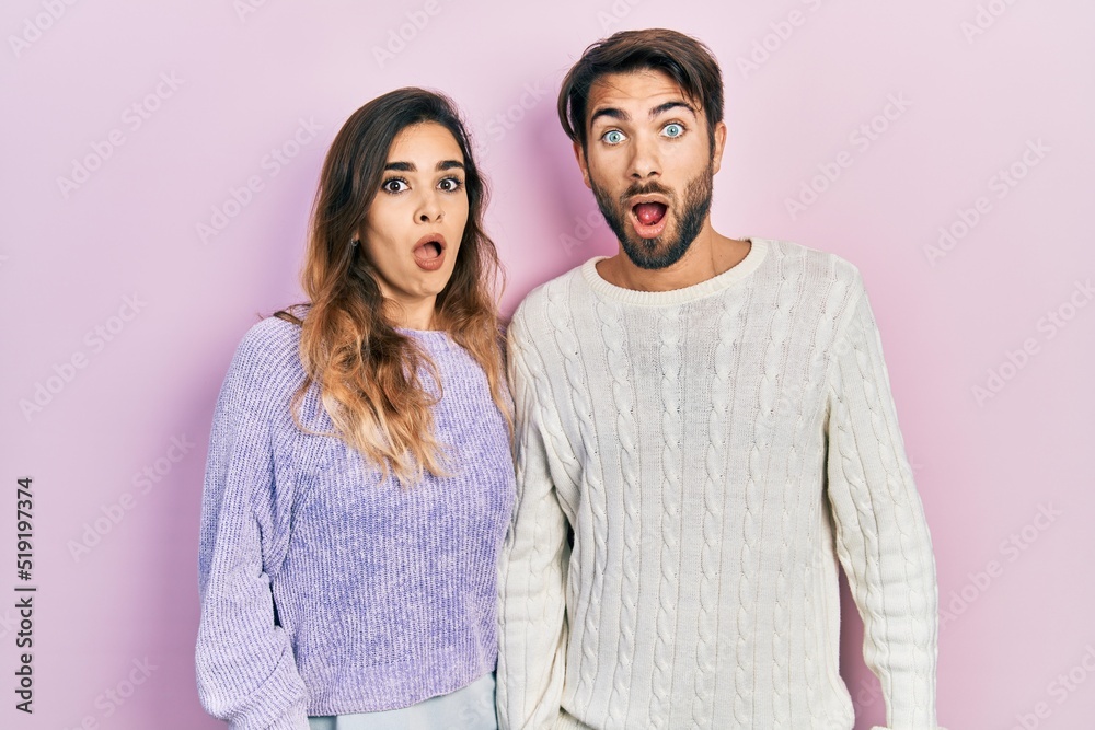 Young hispanic couple wearing casual clothes afraid and shocked with surprise and amazed expression, fear and excited face. Young hispanic couple wearing casual clothes afraid and shocked with surprise and amazed expression, fear and excited face.