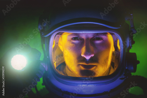 Spaceman in the in helmet with the flashlight in hand.