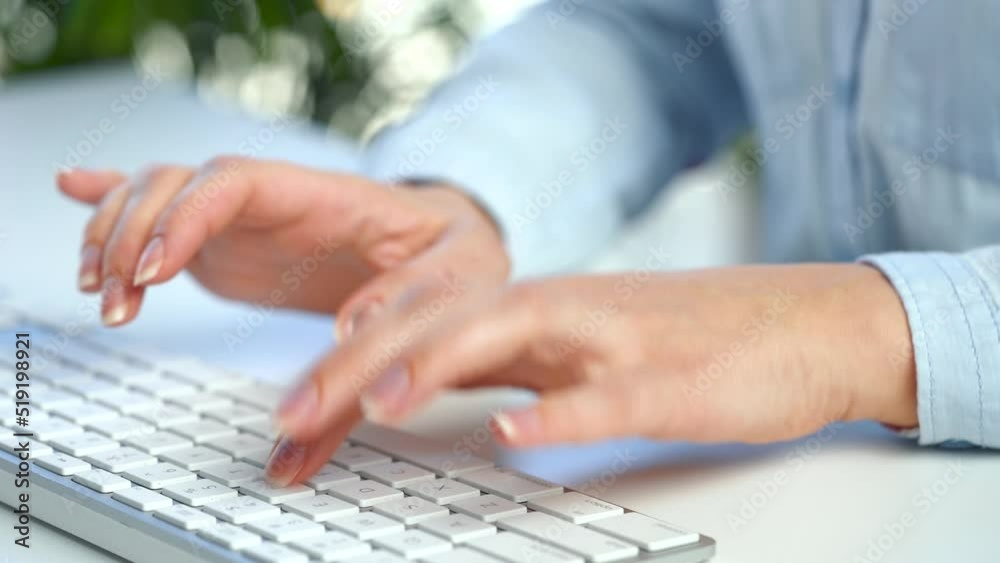 Female hands busy working on computer keyboard for sending emails and surf on a web browser
