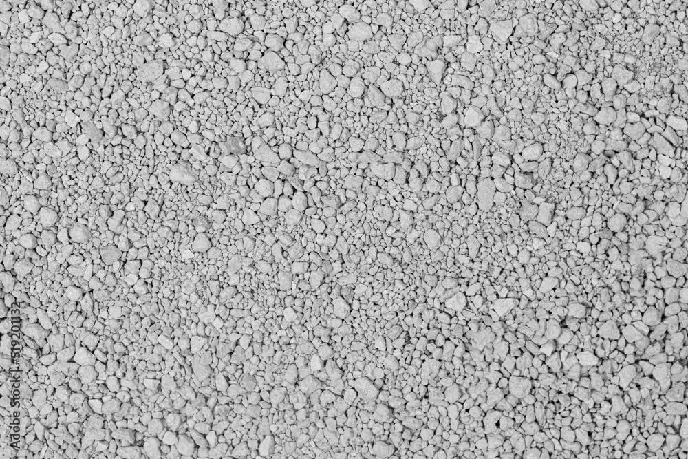 Small rocks ground texture background. white road stone. gravel pebbles stone texture. crushed granite. close up. grey clumping clay. cat litter