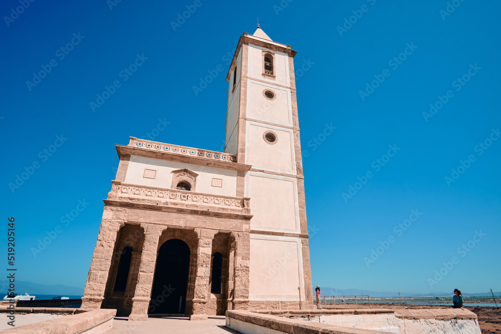 church Las Salinas of Cabo de Gata, built in year 1907, next to the road and the beach in Almadraba de Monteleva (Almeria, Andalusia, Spain, Europe)