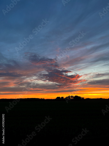 Orange sunset with purple cloud in the landscape, black silhouette of the landscape