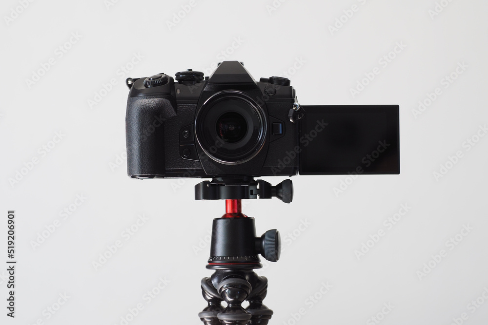 Digital camera with flip screen and wide angle view lens, mounted on tripod for video blog.