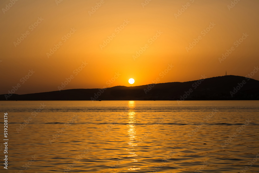 View of Aegean sea and landscape at sunset captured in Ayvalik area of Turkey in summer.