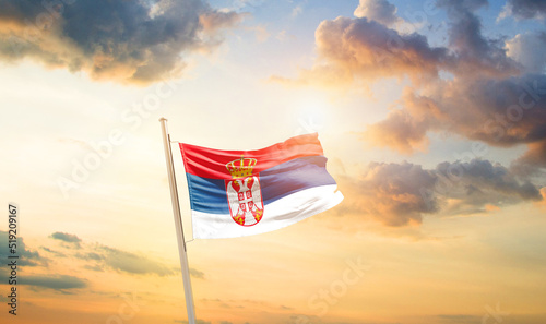 Serbia national flag cloth fabric waving on the sky - Image photo