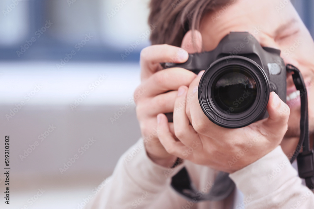 Professional photographer with camera on blurred background. Space for text Professional photographer with camera on blurred background. Space for text