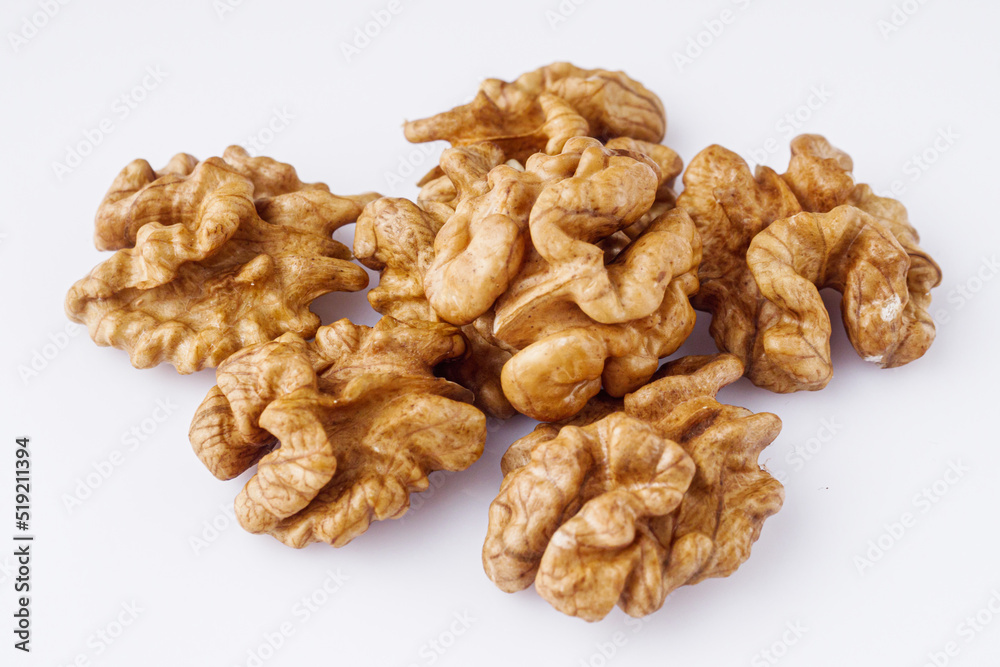 dried walnuts on a white acrylic background dried walnuts on a white acrylic background