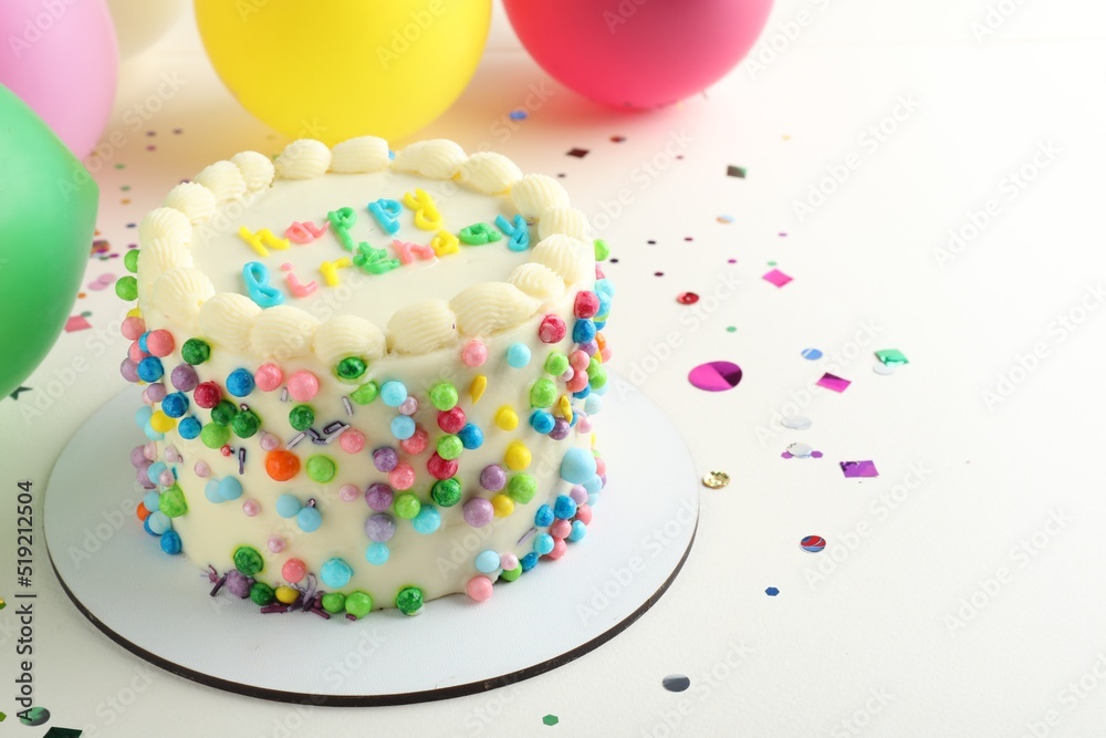 Cute bento cake with tasty cream and decor on white background