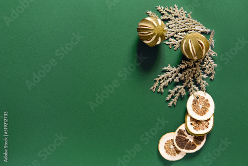 christmas decor on green background, dried lime, top view, copy space