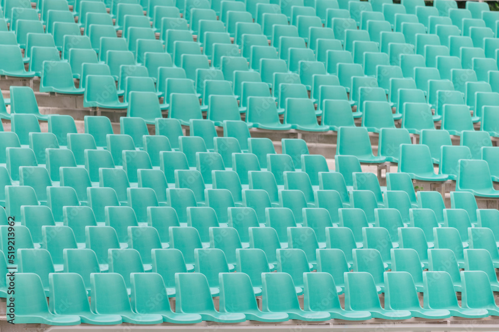 Fototapeta premium rows of plastic empty seats in an outdoor stadium