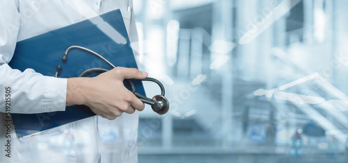 Bilde på lerret A doctor with documents and a stethoscope stands .