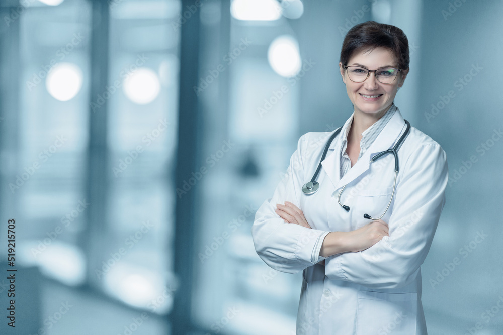 Woman doctor smiling with arms crossed . Woman doctor smiling with arms crossed .