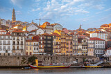 City of Oporto, Portugal in the margins of the Douro river. Douro river in the city of Oporto with traditional boats to transport the famous Oporto Wine from the wineries up river