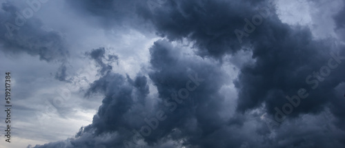 Fotografie, Obraz The dark sky with heavy clouds converging and a violent storm before the rain