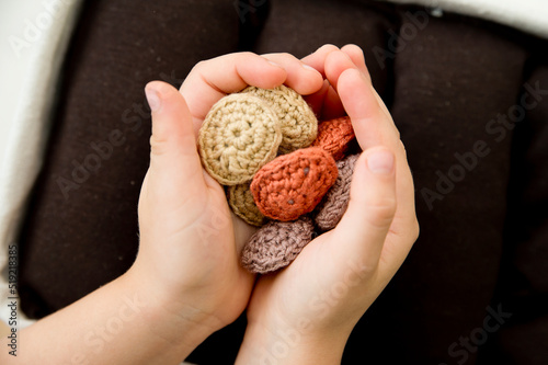 Boy is playing a gardener game. sowing the seeds in bed. Healthy food for children. Gardening and farming concept. Activities at home. Knowledge of country work. Handmade knitted toys - beans.