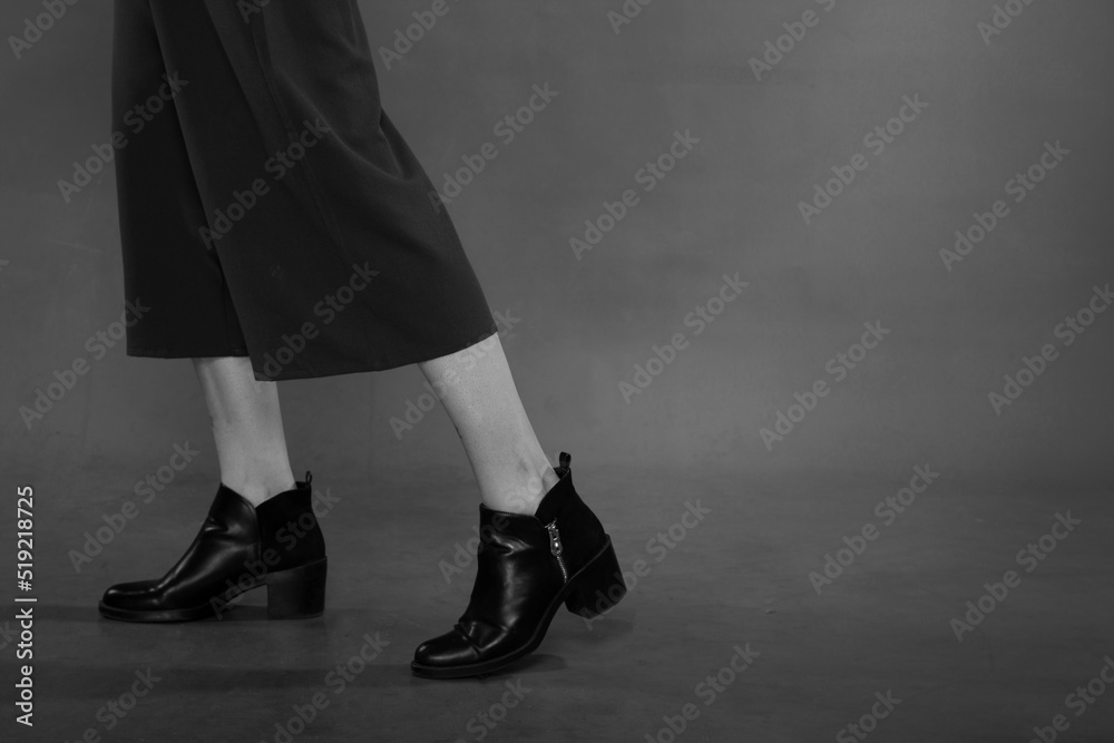 Female legs in boots in black and white Female legs in boots in black and white
