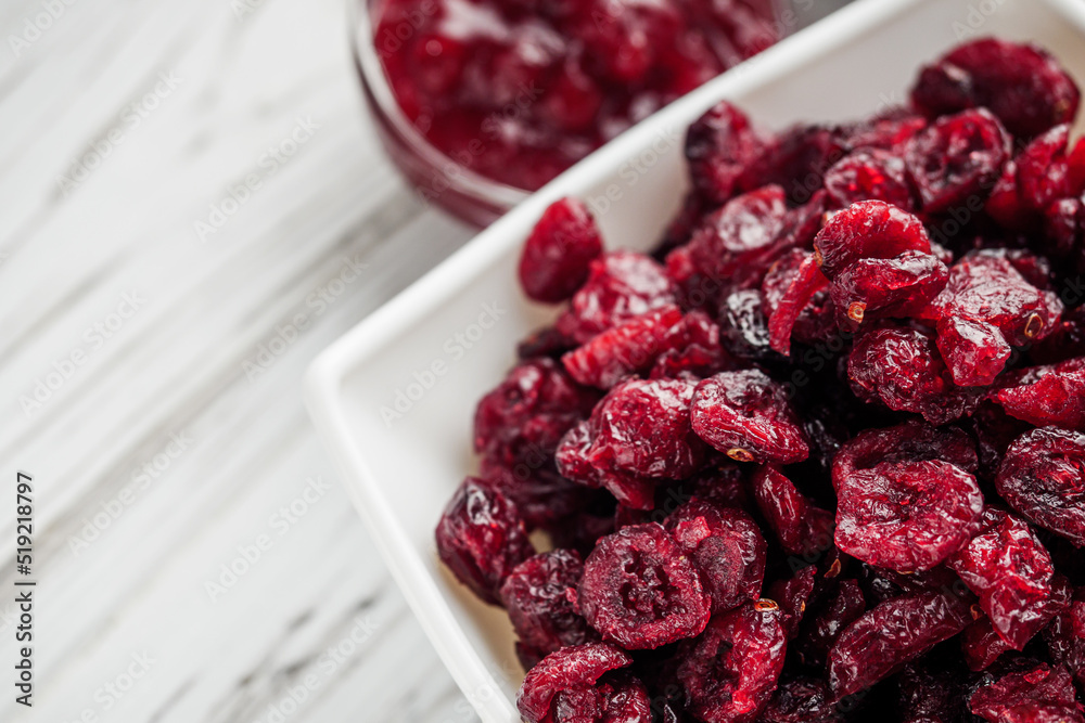 dried cranberry berry on a white wooden rustic background dried cranberry berry on a white wooden rustic background