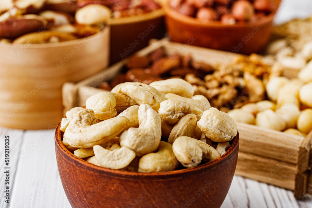 set of different nuts on a white wooden rustic background set of different nuts on a white wooden rustic background