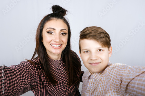 Parenting teen boys, Raising a teen. Studio portrait of Happy Teen boy hugging his mom