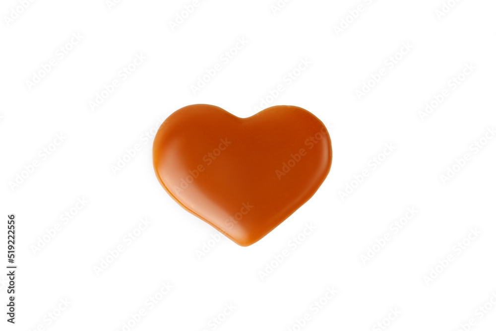 Caramel drop of sweet caramel sauce in heart form isolated on white background. Melted heart of liquid toffee.
