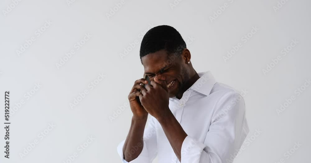 Young African American businessman talking on mobile phone over white background Young African American businessman talking on mobile phone over white background