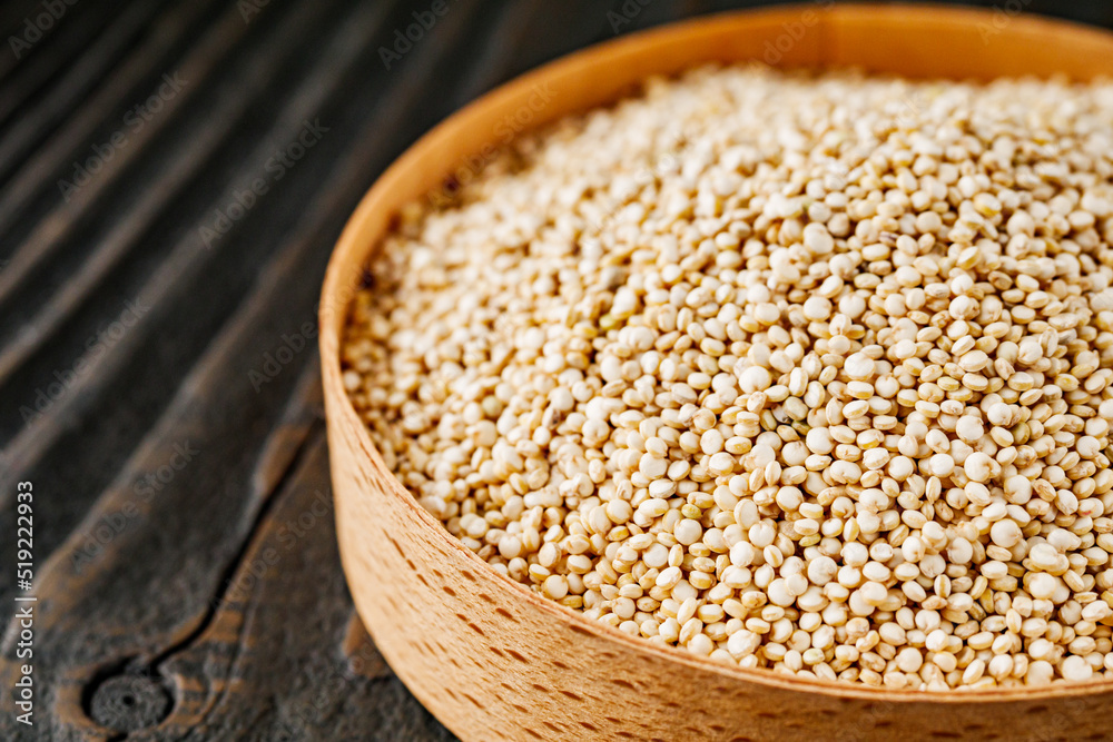 white quinoa seeds on a dark rustic background white quinoa seeds on a dark rustic background