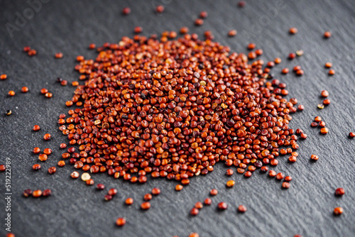 red quinoa seeds on a dark rustic background