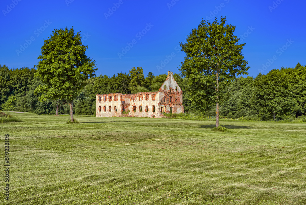 Old manor bricks ruins with forest in background, republic of paulava, lithuania.