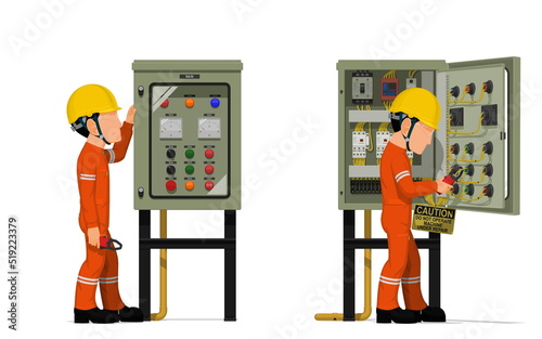 Industrial workers use clamp meter to measuring electric current in the electrical control cabinet
