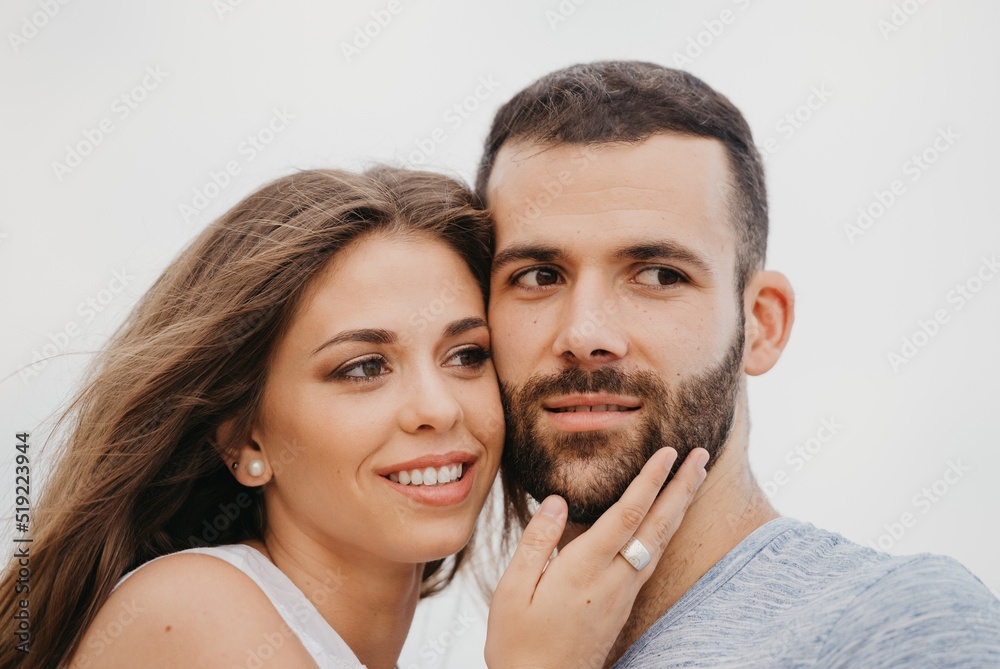 A man and his girlfriend are cuddling up to each other on a rocky hill in Spain