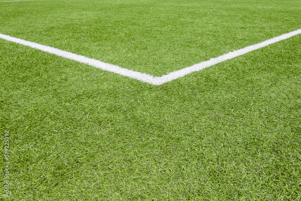 Green synthetic artificial grass soccer sports field with white stripe line