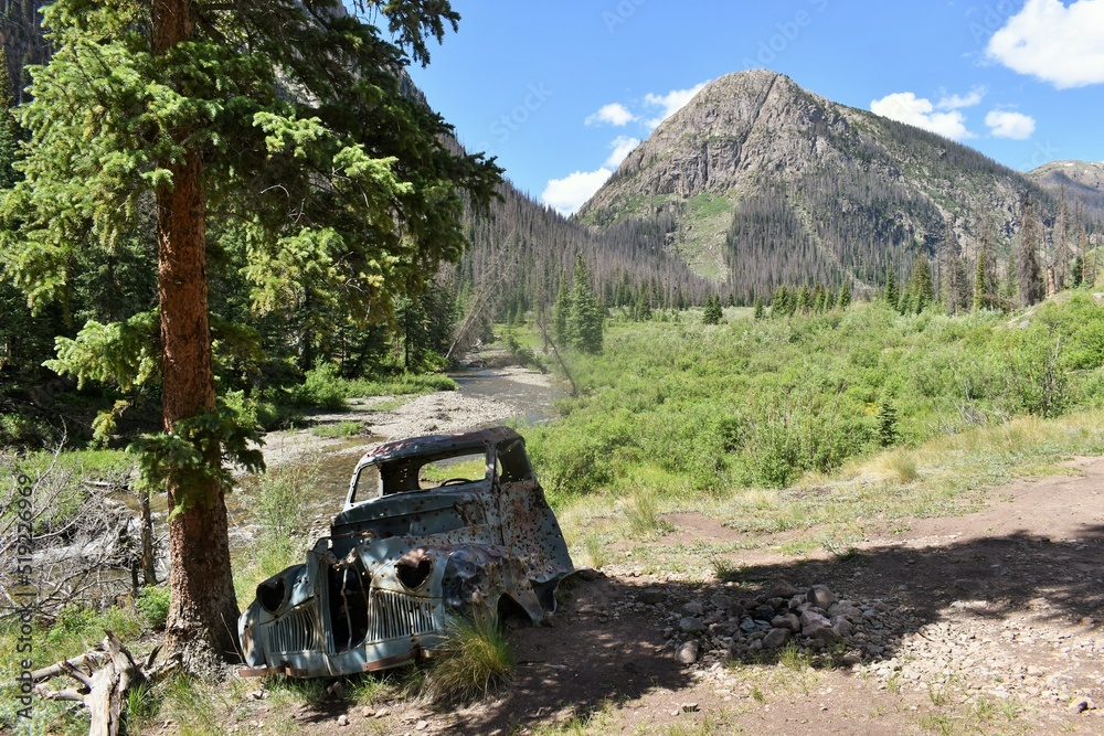Old truck abandoned by a creek in the mountains
