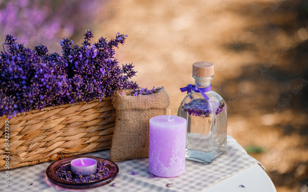 Basket with beautiful lavender in the field in Provance with Lavander water and candles. Harvesting season Basket with beautiful lavender in the field in Provance with Lavander water and candles. Harvesting season