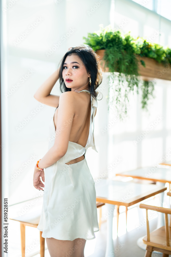 Portrait beautiful asian freelance Success people business woman fashion model in summer white sleeveless dress and coffee in cup in coffee shop. Portrait beautiful asian freelance Success people business woman fashion model in summer white sleeveless dress and coffee in cup in coffee shop.